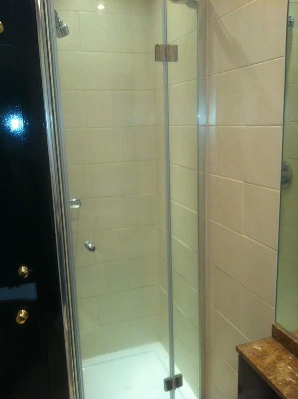 Frameless glass shower enclosure with chrome fittings in Radlett